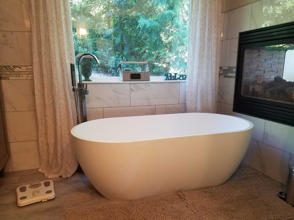 Inspiration for a large contemporary master bathroom in Sacramento with a freestanding tub.
