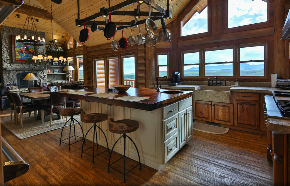 Design ideas for a large country l-shaped open plan kitchen in Atlanta with a farmhouse sink, raised-panel cabinets, medium wood cabinets, wood benchtops, brown splashback, timber splashback, stainless steel appliances, dark hardwood floors, with island and brown floor.