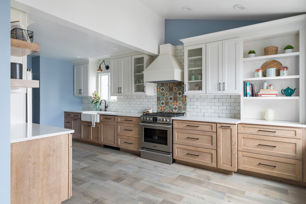 Example of a mid-sized country galley gray floor and vaulted ceiling enclosed kitchen design in New York with shaker cabinets, white cabinets, quartz countertops, multicolored backsplash, ceramic backsplash, stainless steel appliances, no island and white countertops