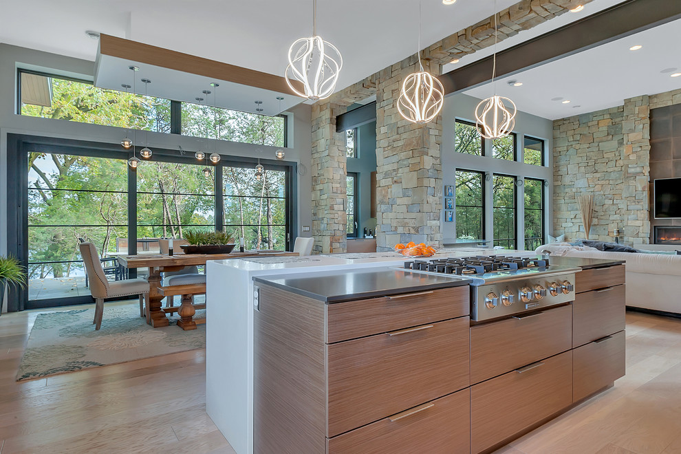 This is an example of a large contemporary open plan kitchen in Minneapolis with light hardwood floors and beige floor.