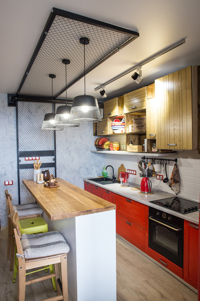 Photo of an industrial single-wall kitchen in Other with a peninsula.
