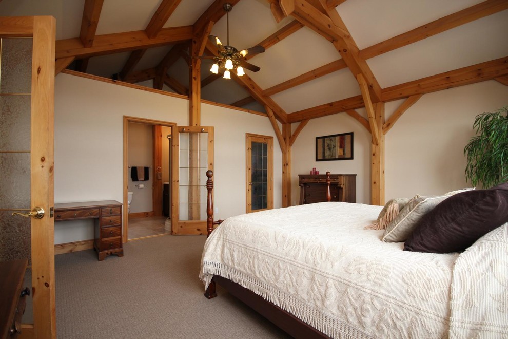 Photo of a country loft-style bedroom in Ottawa with beige walls and carpet.