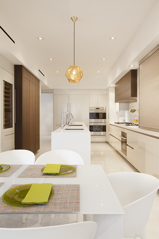 Inspiration for a modern kitchen in Miami with an undermount sink, white cabinets, marble benchtops, white splashback, porcelain splashback, stainless steel appliances, porcelain floors and with island.