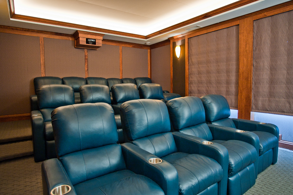 Large tropical open concept home theatre in Hawaii with green walls, carpet, a built-in media wall and grey floor.