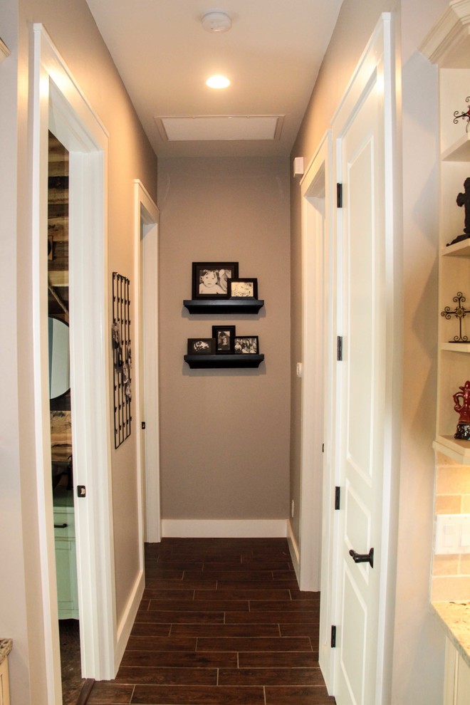 Design ideas for a mid-sized beach style hallway in Miami with grey walls, medium hardwood floors and brown floor.