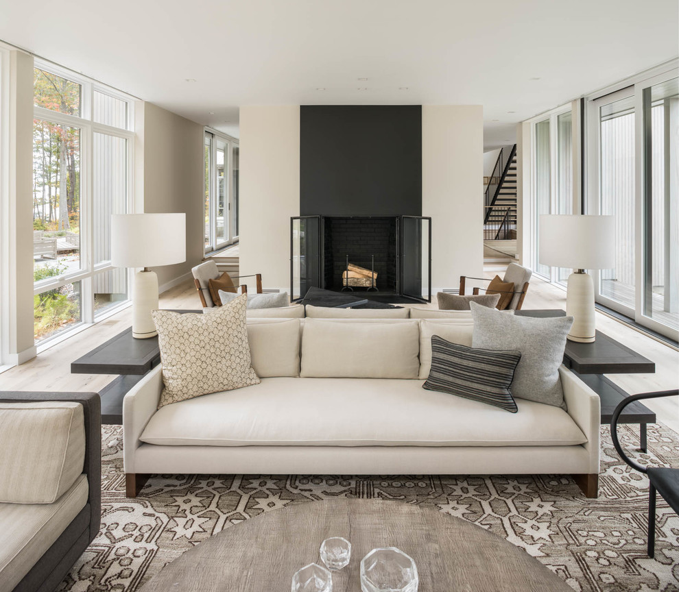 Inspiration for a contemporary open concept living room in Portland Maine with beige walls and a standard fireplace.