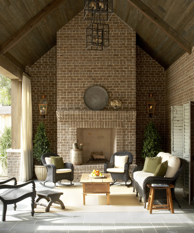 Inspiration for a traditional patio in Houston with a fire feature and a roof extension.
