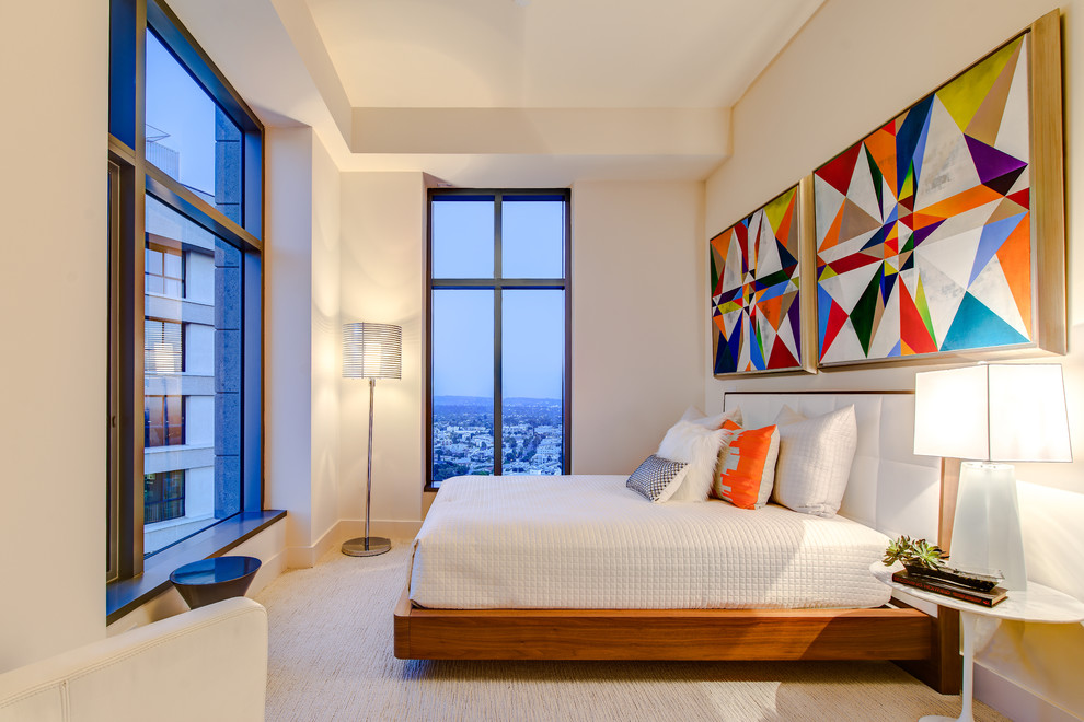 Contemporary bedroom in Los Angeles with beige walls and carpet.