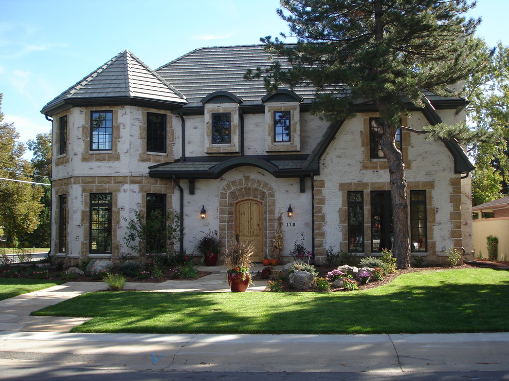 Design ideas for a traditional two-storey white exterior in Denver with a hip roof.