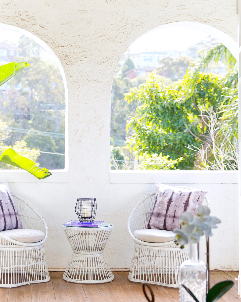 Design ideas for a mid-sized transitional balcony in Sydney with a roof extension.