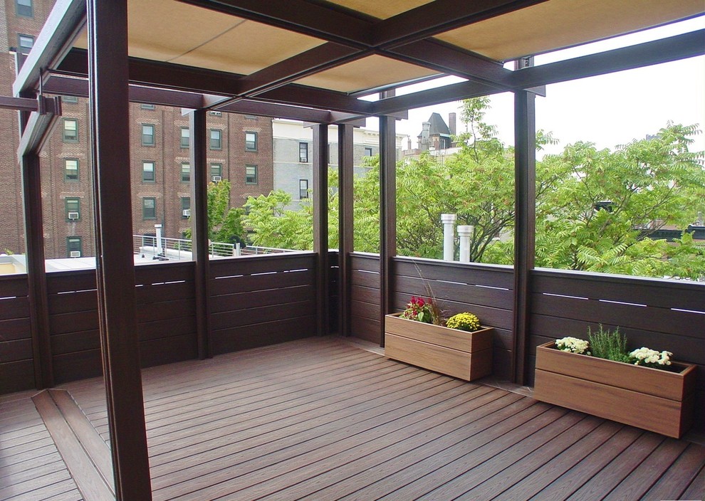 Inspiration for a large transitional rooftop deck in New York with an awning.