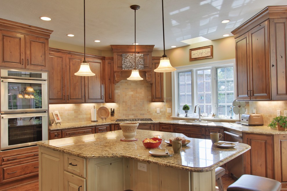 Inspiration for a mid-sized medium tone wood floor eat-in kitchen remodel with an undermount sink, medium tone wood cabinets, quartzite countertops, beige backsplash, ceramic backsplash, stainless steel appliances and an island