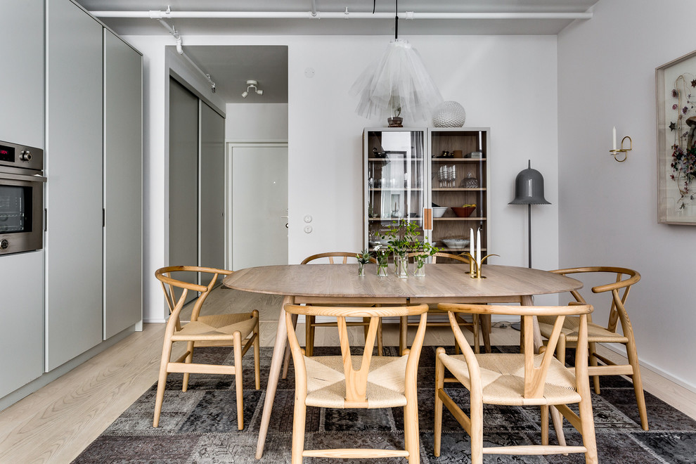 Inspiration for a scandinavian dining room in Stockholm with light hardwood floors.