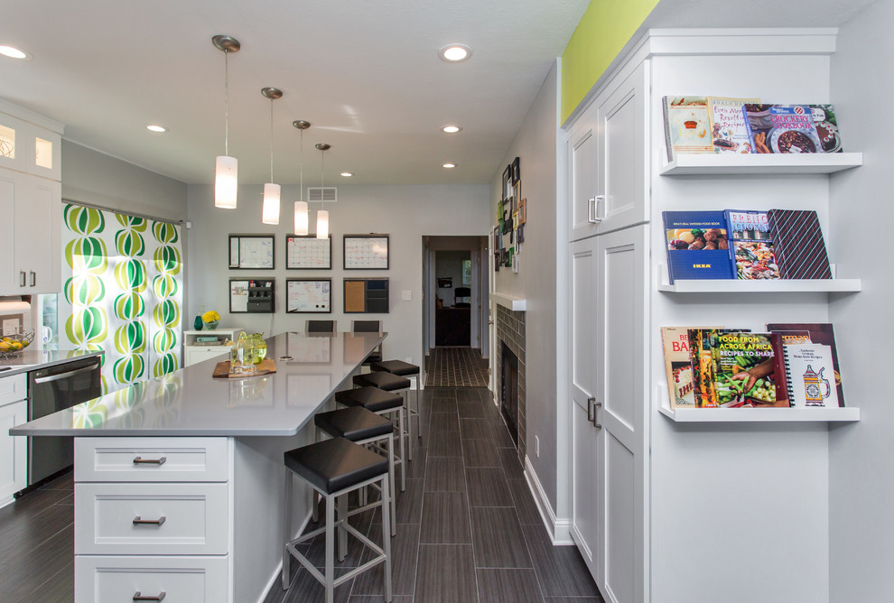 Mid-sized transitional u-shaped porcelain tile enclosed kitchen photo with a drop-in sink, recessed-panel cabinets, white cabinets, quartz countertops, gray backsplash, ceramic backsplash, stainless steel appliances and an island