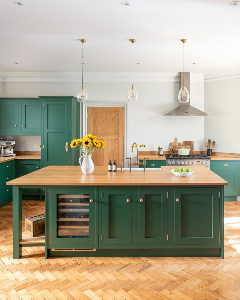 Inspiration for a mid-sized country eat-in kitchen in Berkshire with a farmhouse sink, green cabinets, wood benchtops, with island and beige benchtop.