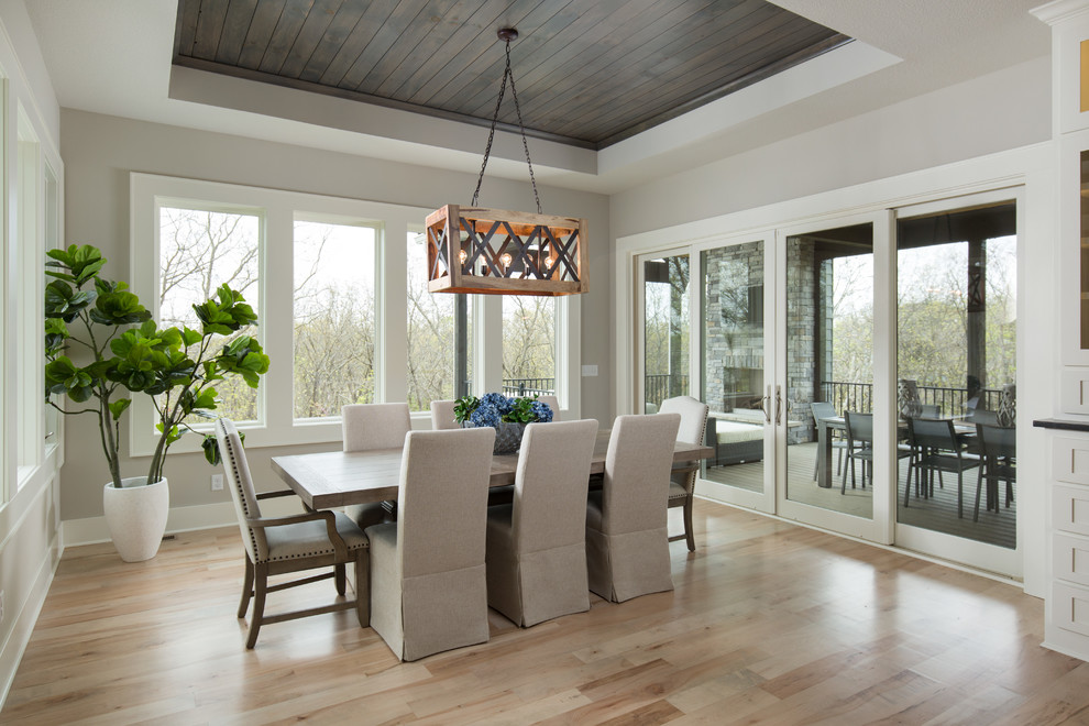 Design ideas for a beach style dining room in Dallas with beige walls, light hardwood floors and beige floor.