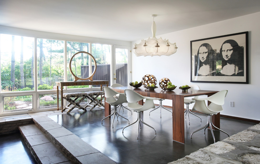 Photo of a large modern dining room in St Louis with concrete floors, grey floor, white walls and no fireplace.