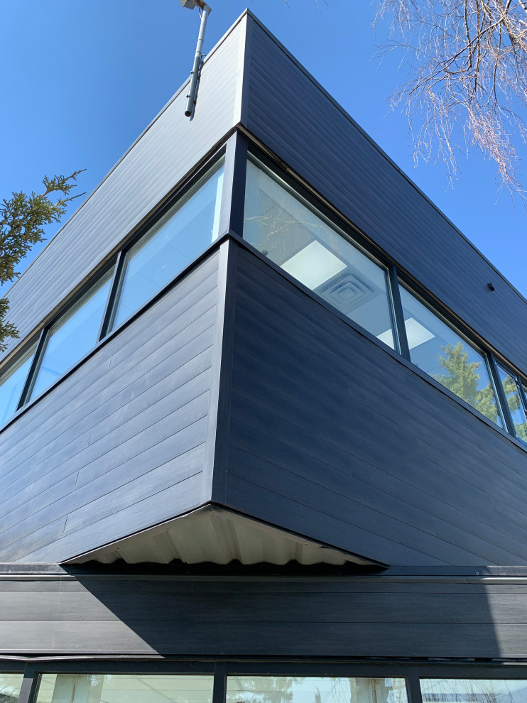 Photo of a modern black exterior in Toronto with metal siding.