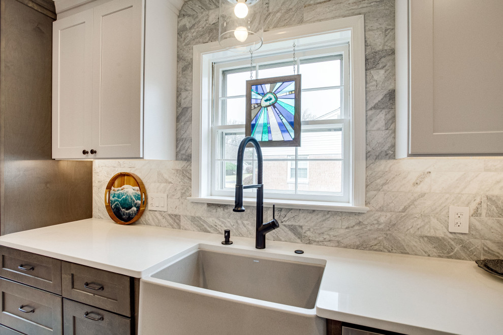 Kitchen - small transitional single-wall kitchen idea in DC Metro with a farmhouse sink, quartz countertops, stainless steel appliances and a peninsula