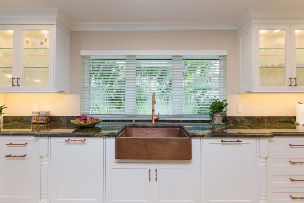 Open concept kitchen - large transitional u-shaped light wood floor open concept kitchen idea in Miami with a farmhouse sink, shaker cabinets, stainless steel appliances, an island, white cabinets, granite countertops, metallic backsplash and mosaic tile backsplash