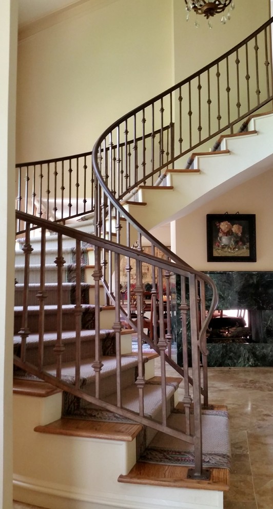 This is an example of an arts and crafts metal floating staircase in Houston with metal risers.