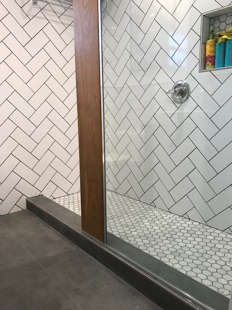 This is an example of a small 3/4 bathroom in Los Angeles with furniture-like cabinets, brown cabinets, a one-piece toilet, white tile, porcelain tile, white walls, cement tiles, a vessel sink, wood benchtops and grey floor.