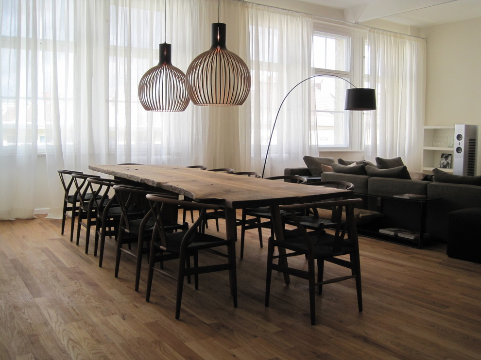 Inspiration for a large contemporary open plan dining in Berlin with beige walls and medium hardwood floors.