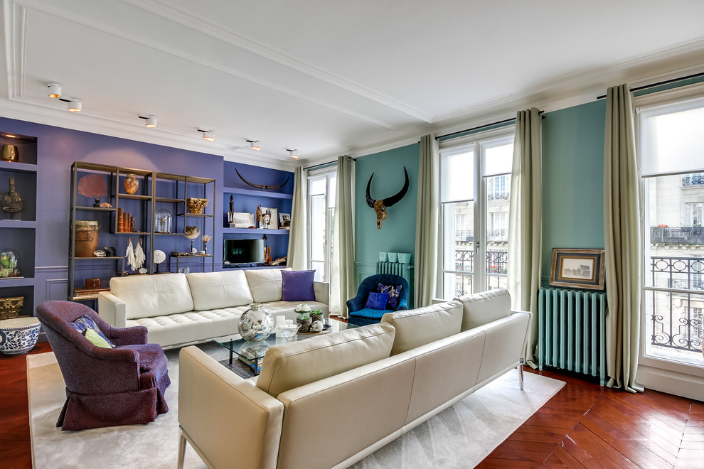 Design ideas for a large eclectic enclosed living room in Paris with a library, medium hardwood floors, no fireplace, a freestanding tv and multi-coloured walls.