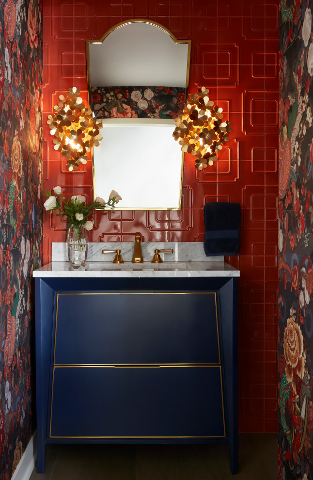 Powder room - mid-sized eclectic orange tile and porcelain tile light wood floor, gray floor and wallpaper powder room idea in Los Angeles with flat-panel cabinets, blue cabinets, a one-piece toilet, multicolored walls, an undermount sink, solid surface countertops, white countertops and a freestanding vanity