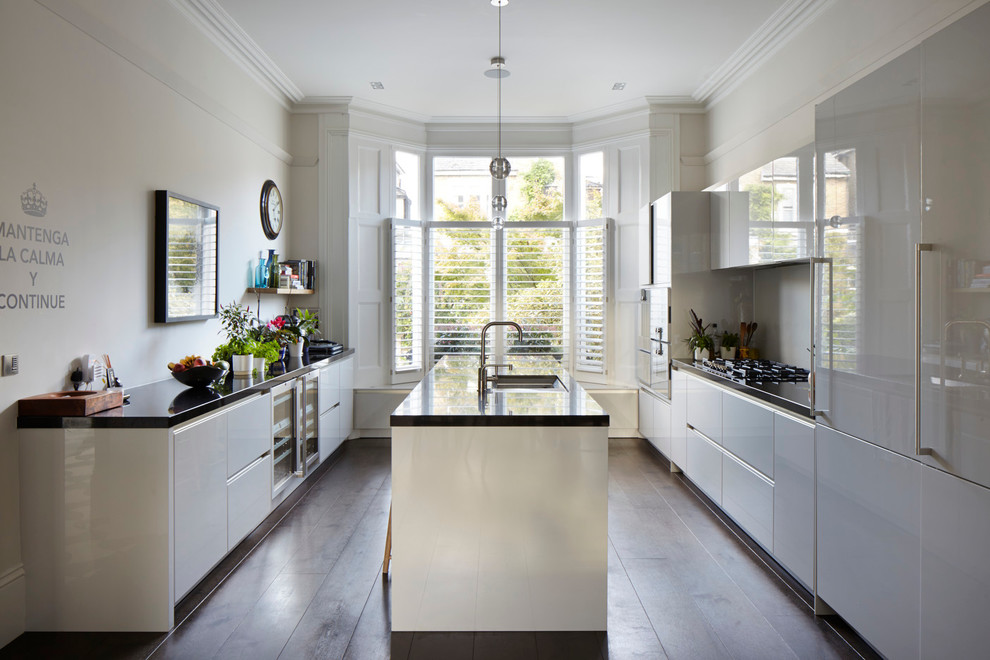This is an example of a contemporary kitchen in London with with island.