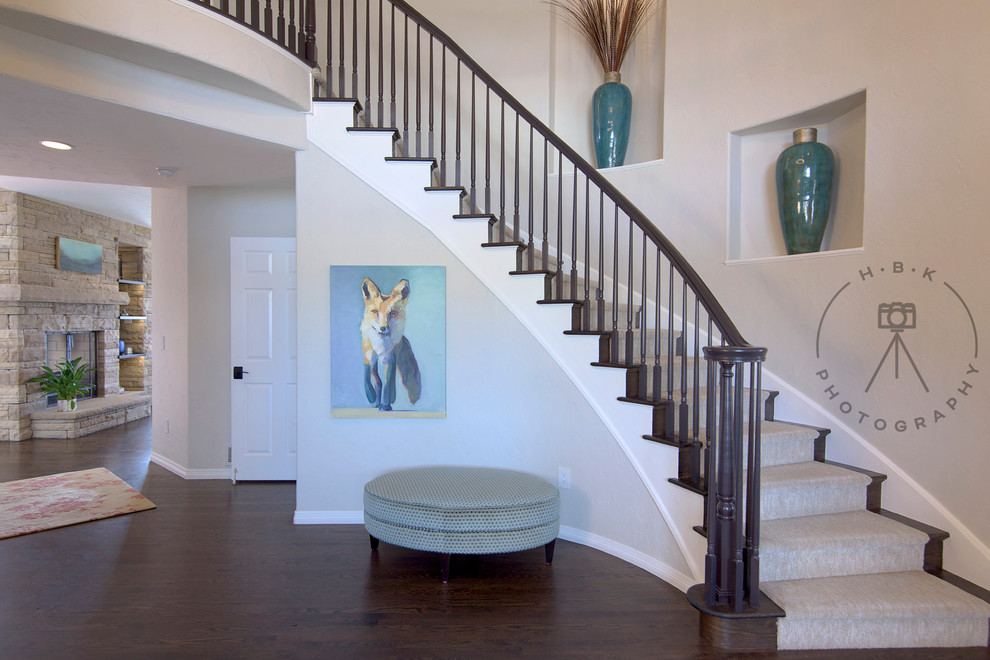 Example of a large dark wood floor and brown floor foyer design with gray walls