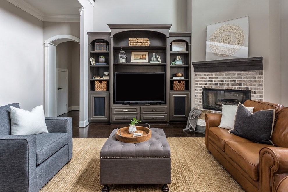 Inspiration for a mid-sized transitional open concept family room in Houston with grey walls, dark hardwood floors, a corner fireplace, a brick fireplace surround, a built-in media wall and black floor.