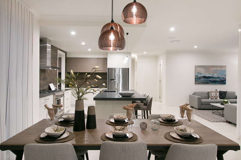 Photo of a mid-sized contemporary open plan dining in Gold Coast - Tweed with white walls.