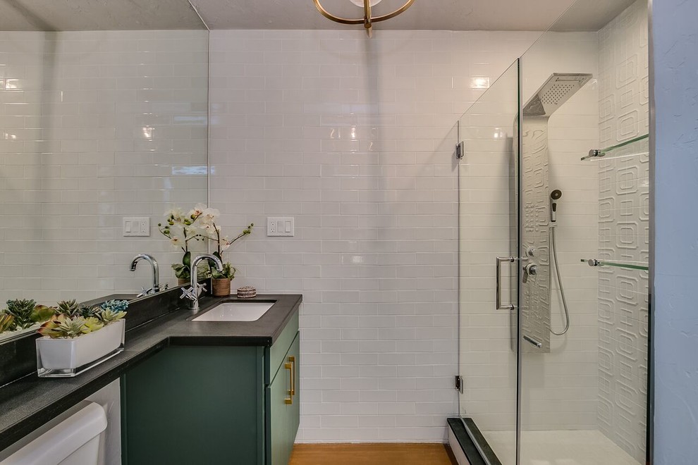 Alcove shower - mid-sized transitional 3/4 white tile and subway tile concrete floor and brown floor alcove shower idea in Phoenix with flat-panel cabinets, green cabinets, gray walls, an undermount sink and a hinged shower door