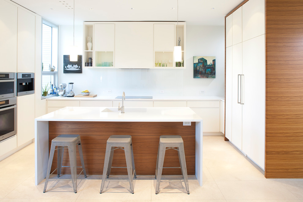 Inspiration for a large modern u-shaped open plan kitchen in Toronto with flat-panel cabinets, white cabinets, white splashback, with island, a drop-in sink, solid surface benchtops, glass sheet splashback, stainless steel appliances and ceramic floors.
