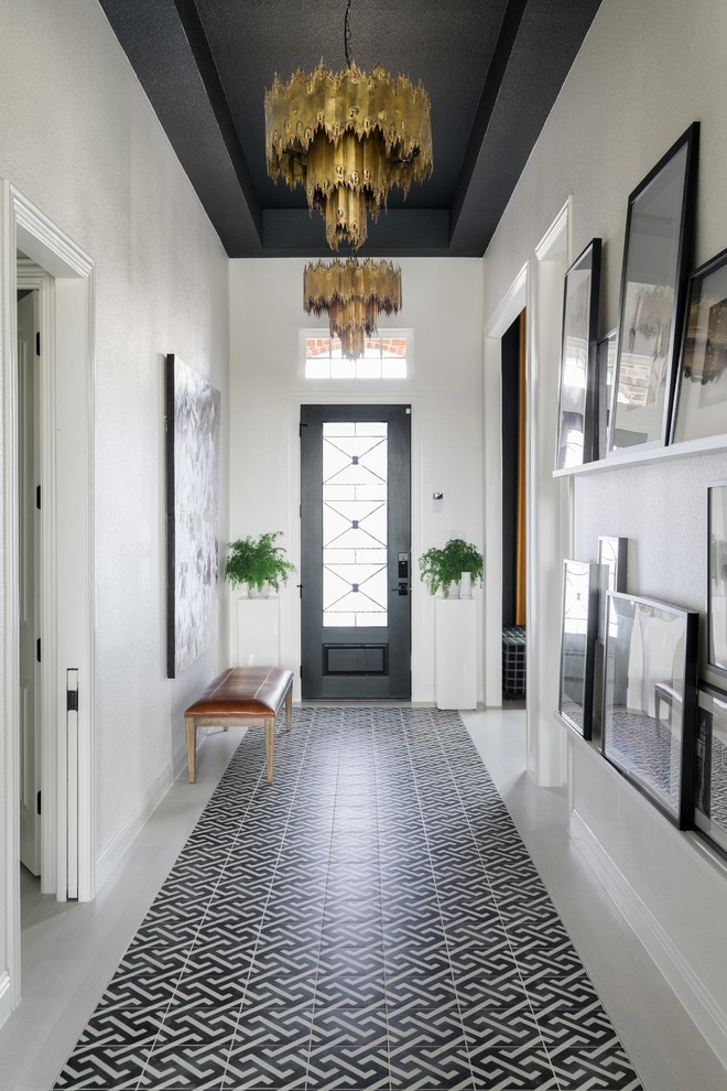 This is an example of a large transitional foyer in Chicago with white walls, ceramic floors, a single front door, a black front door and white floor.