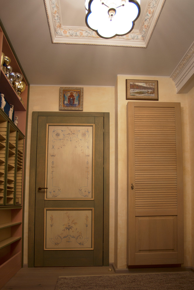 This is an example of a mid-sized midcentury entryway in Moscow with beige walls, medium hardwood floors and beige floor.
