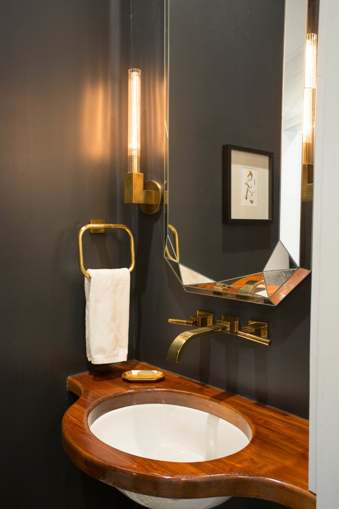 Small transitional powder room in New Orleans with an undermount sink, wood benchtops and black walls.