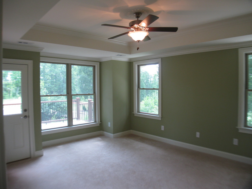 Arts and crafts master bedroom in Other with green walls and carpet.