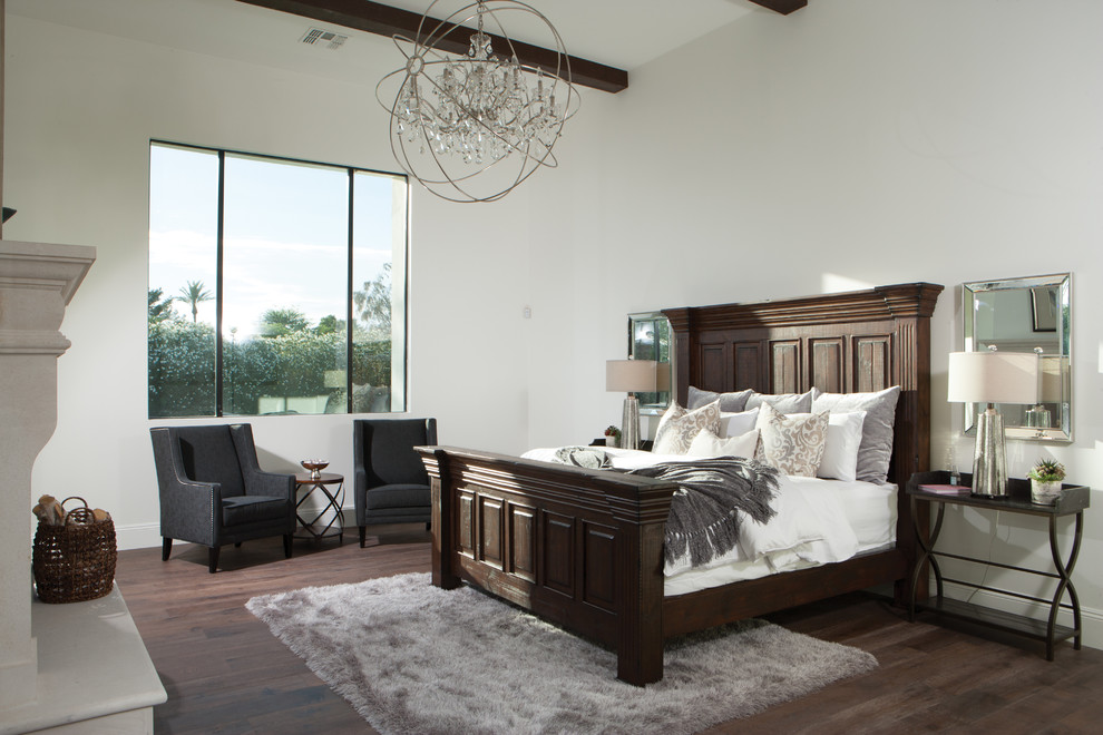 Design ideas for a mid-sized transitional master bedroom in Phoenix with beige walls, dark hardwood floors, a standard fireplace, a stone fireplace surround and brown floor.