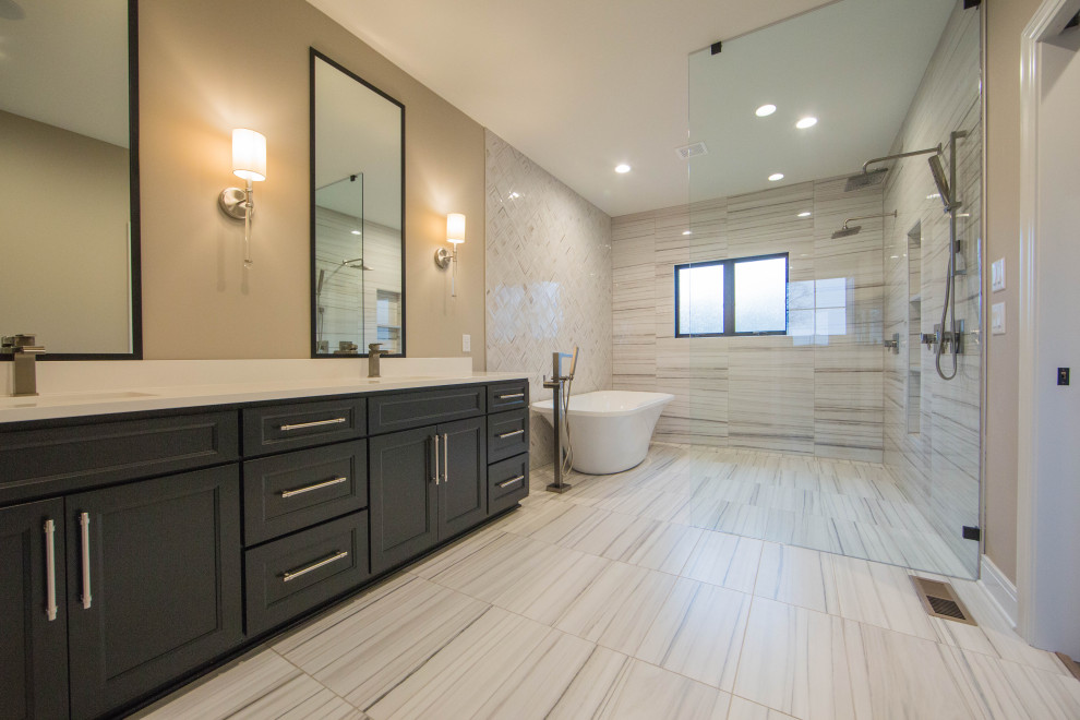 Photo of a large arts and crafts master wet room bathroom in Indianapolis with recessed-panel cabinets, dark wood cabinets, a freestanding tub, white tile, stone slab, multi-coloured walls, an integrated sink, multi-coloured floor, an open shower, white benchtops, a double vanity and a built-in vanity.