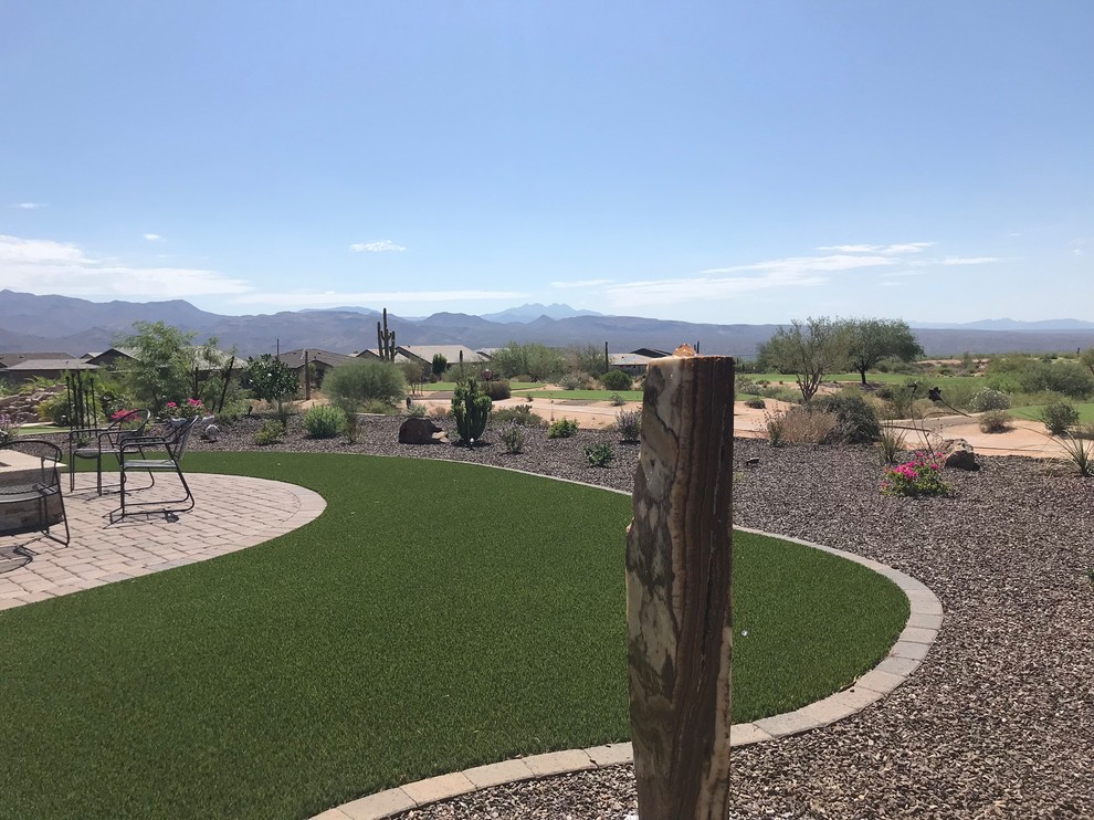 Design ideas for a large rustic drought-tolerant and full sun backyard concrete paver water fountain landscape in Phoenix.
