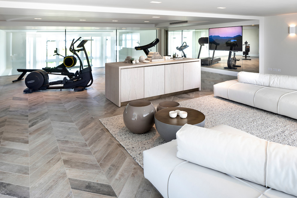 Photo of a large contemporary multipurpose gym in Cheshire with white walls, porcelain floors and grey floor.