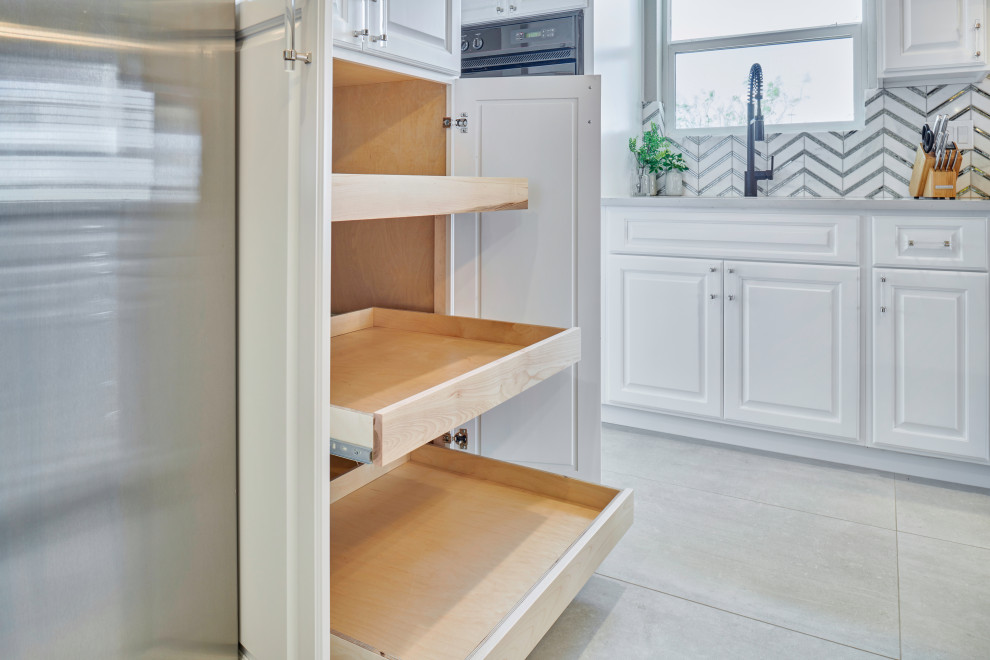 Example of a small transitional l-shaped porcelain tile and gray floor eat-in kitchen design with an undermount sink, beaded inset cabinets, white cabinets, quartzite countertops, multicolored backsplash, glass sheet backsplash, black appliances, a peninsula and white countertops