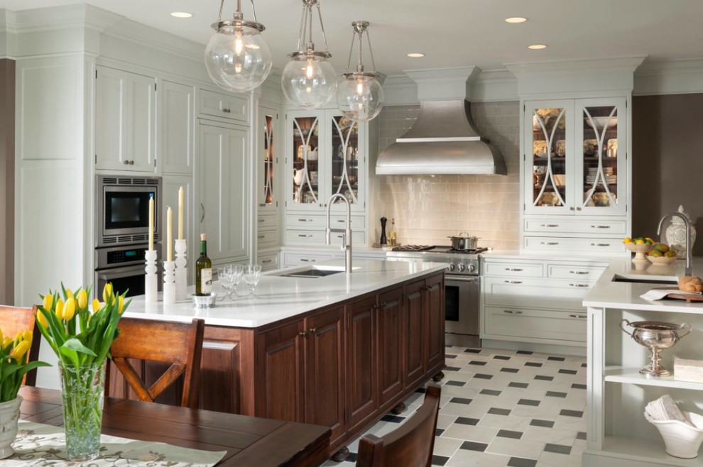Inspiration for a large transitional u-shaped eat-in kitchen in Houston with a single-bowl sink, glass-front cabinets, white cabinets, grey splashback, ceramic splashback, stainless steel appliances, ceramic floors and with island.
