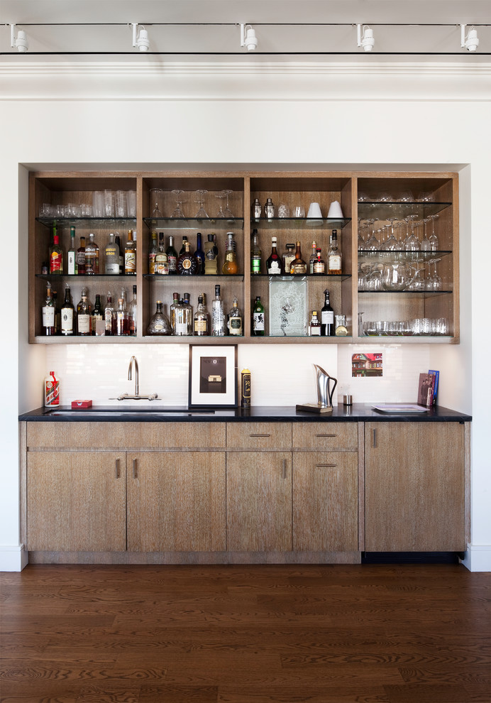 Mid-sized contemporary single-wall wet bar in New York with dark hardwood floors, flat-panel cabinets and medium wood cabinets.