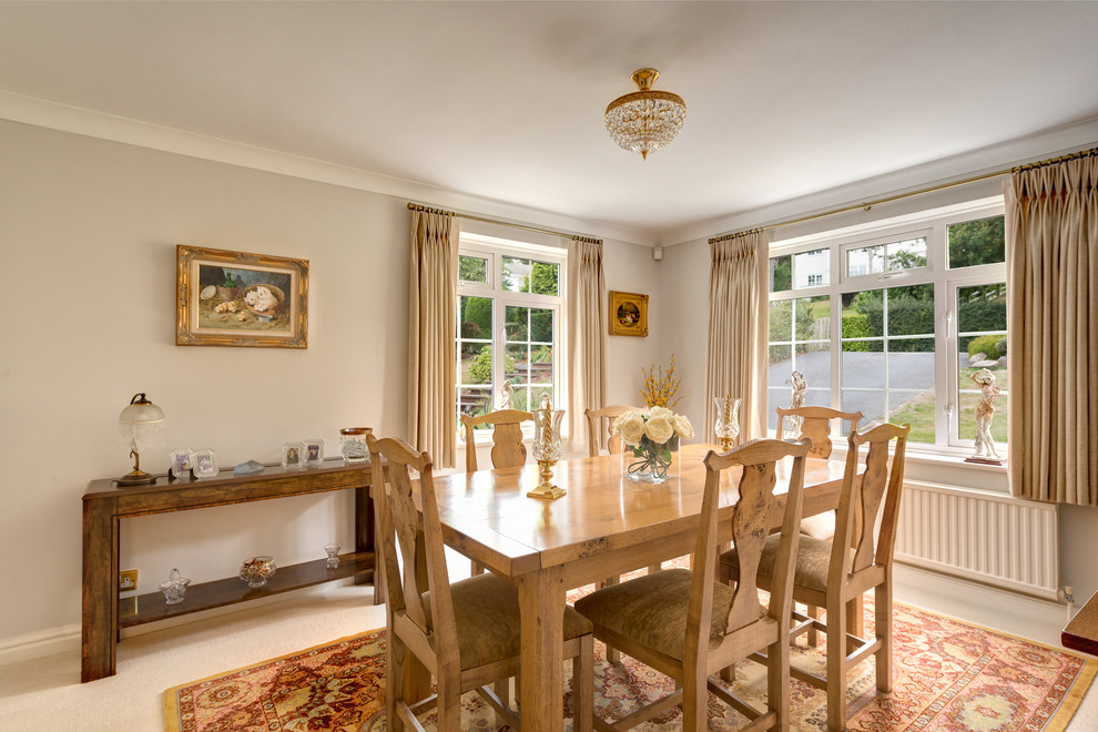 This is an example of a traditional dining room in Devon with grey walls.