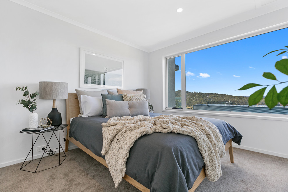 This is an example of a contemporary guest bedroom in Hobart with white walls, carpet and grey floor.