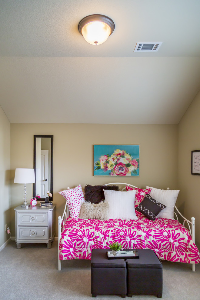 This is an example of a mid-sized eclectic guest bedroom in Kansas City with beige walls, carpet and beige floor.