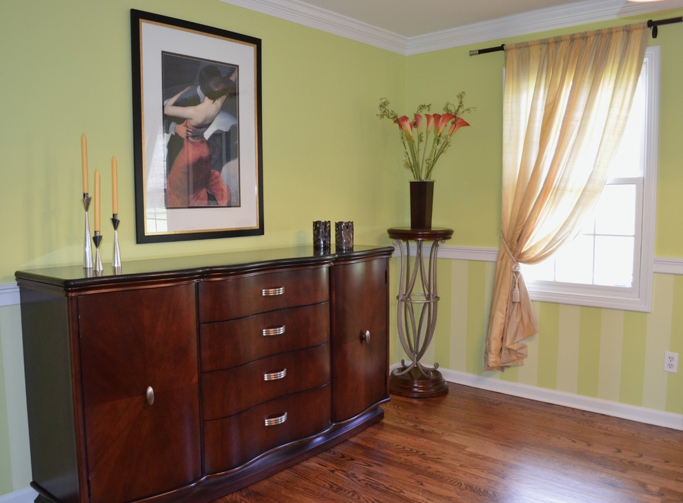 Photo of a mid-sized transitional separate dining room in New York with green walls and dark hardwood floors.